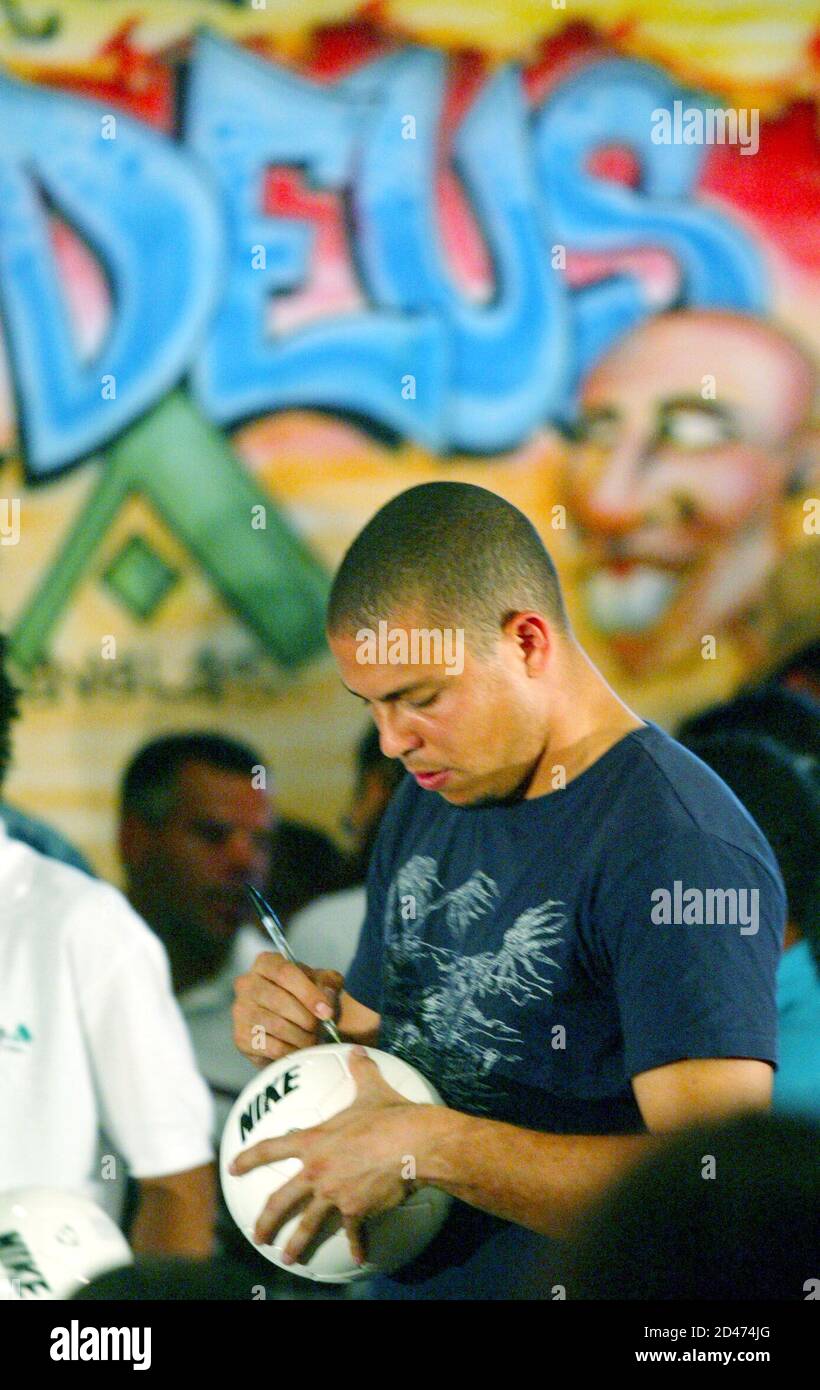 Brazilian Soccer Star Ronaldo Nazario Autographs A Soccer Ball At The Theater Located In The Cidade De Deus Slum In Rio De Janeiro May 26 2004 Ronaldo Is Personally Financing The Renovation