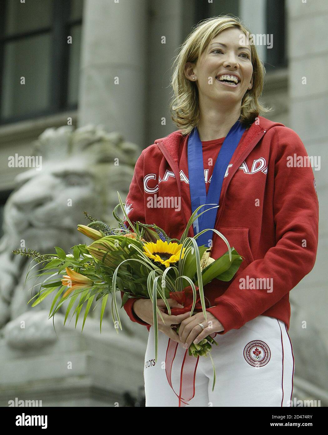 Skier Beckie Scott poses after receiving the gold medal for the 2002  Olympic Winter Games five-kilometer pursuit, at a ceremony in Vancouver  British Columbia, June 25, 2004. Scott, who took the bronze