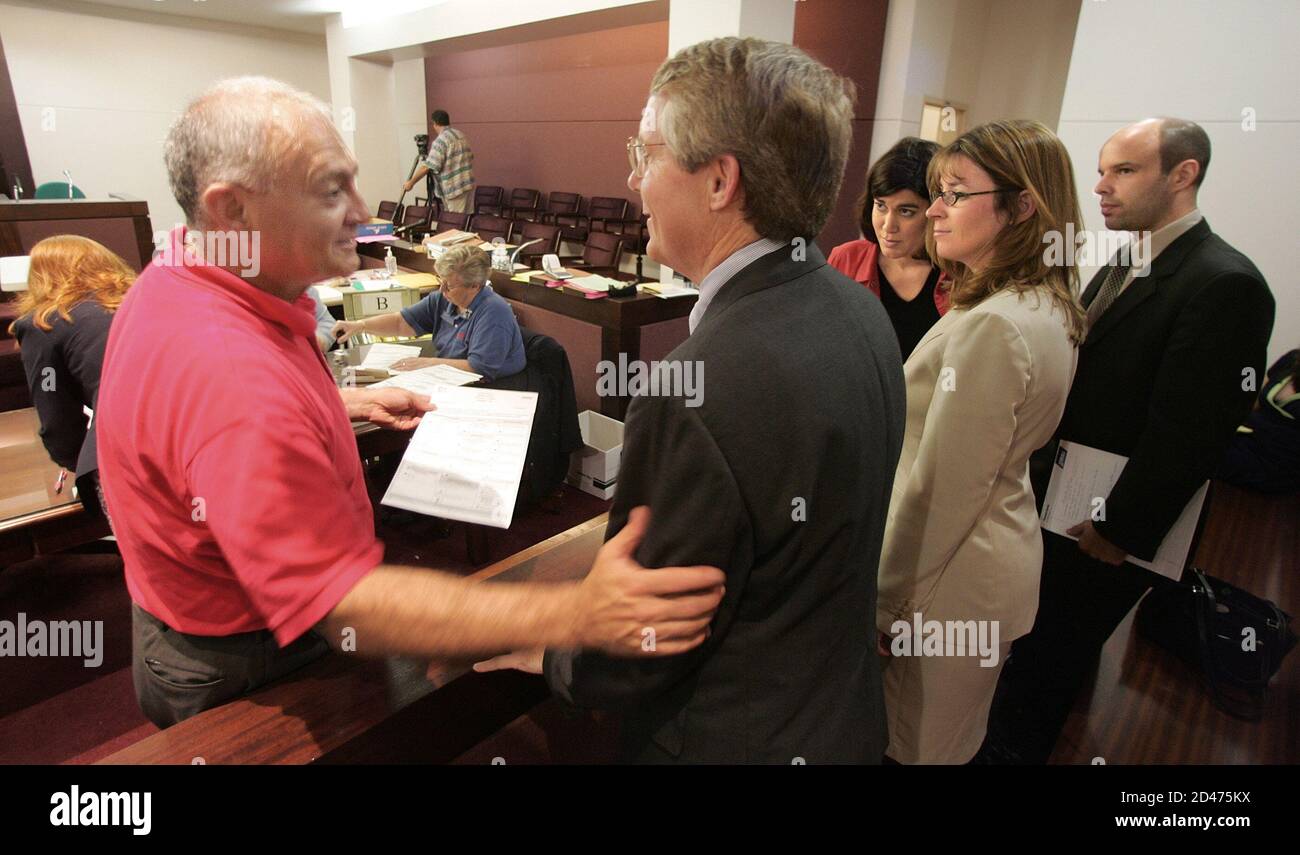 Leon County, Florida, Elections Supervisor and member of the Canvassing Board Lon Sancho (L) reaches across to Doug Roberts, attorney for the Kerry/Edwards campaign to tell him that the ballots they are working on now are not in a position to be challenged November 1, 2004 in Tallahassee. REUTERS/Mark Wallheiser  MW Stock Photo