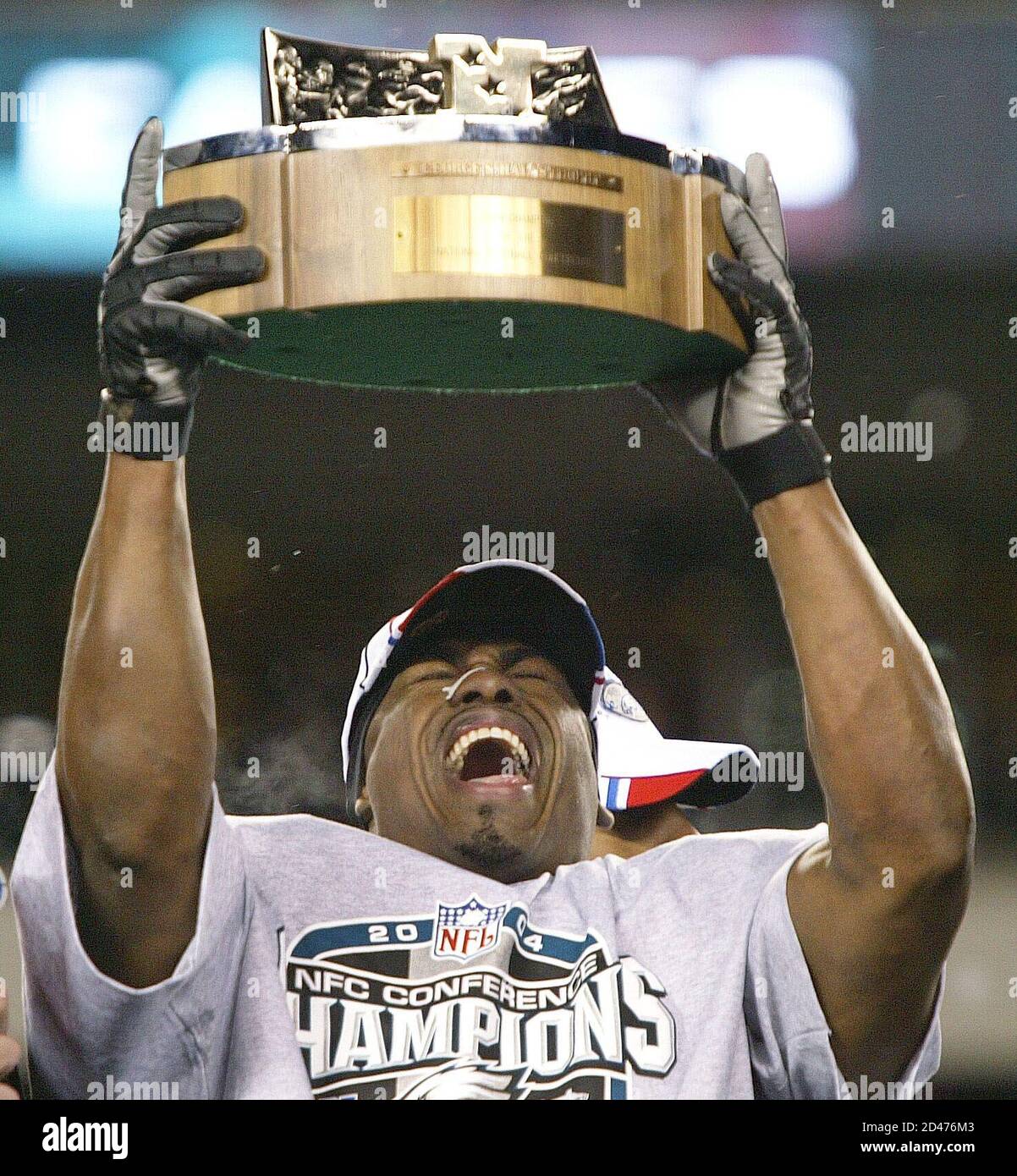 Philadelphia Eagles safety Brian Dawkins holds up the George Halas trophy,  awarded for winning the NFC championship, against the Atlanta Falcons in  Philadelphia, January 23, 2005. The Eagles defeated the Falcons 27-10