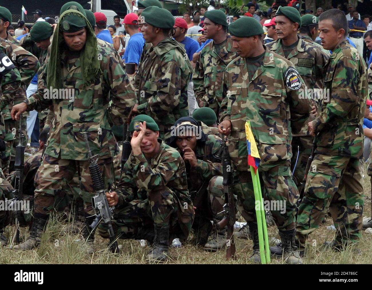 Far-right paramilitary fighters wait as they prepare to surrender their  weapons in in San Pablo, Colombia. Far-right paramilitary fighters wait as  they prepare to surrender their weapons in San Pablo, Colombia, July