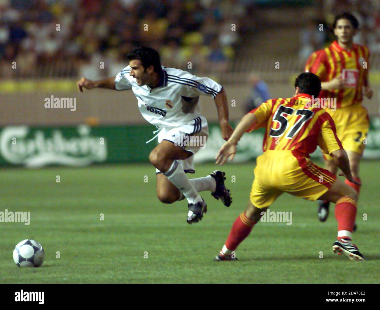 Real Madrid's Portuguese midfielder Luis Figo (L) escapes a tackle by  Galatasaray defender Hakan Unsal (57) in the Louis II stadium in Monaco  August 25, 2000. UEFA Cup winners Galatasaray and Champions'