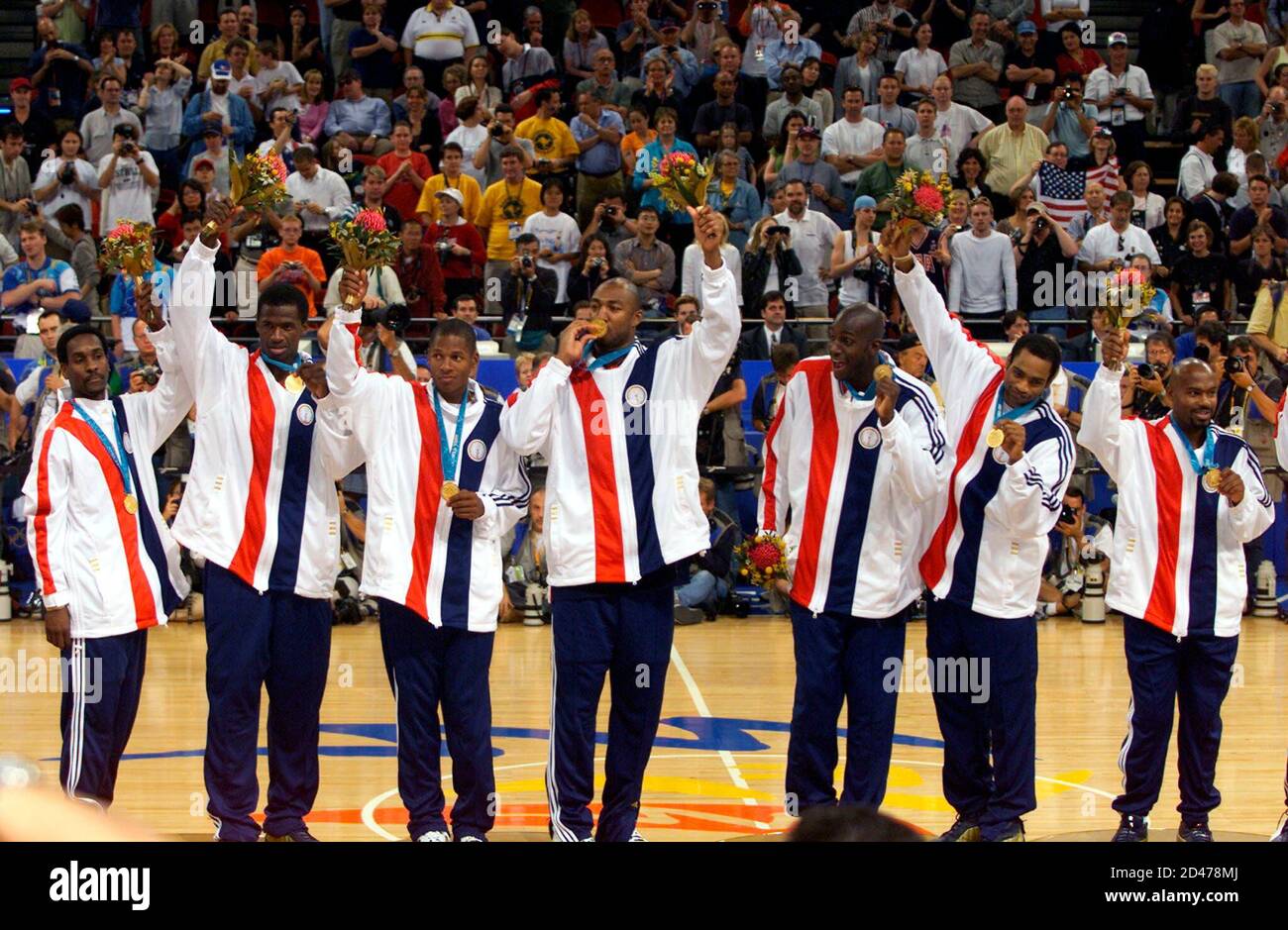 USA basketball players wave on the podium during a presentation ceremony at  the Olympic Games in Sydney, October 1, 2000. USA beat France 85-75 in the  men's final basketball match on Sunday
