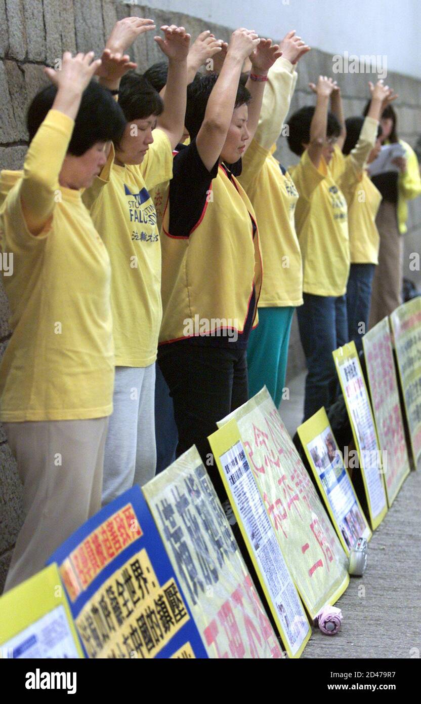 UNCROPPED VERSION OF HKG53D  Falun Gong followers practice 'qigong,' or meditational exercise, in Hong Kong April 25, 2001. About 20 members of the Falun Gong spiritual movement, outlawed in mainland China, demonstrated in central Hong Kong on Wednesday to press Bejing to stop its campaign of what they call 'unreasonable persecution'. The demonstration in Hong Kong, where the group is legal, came on the second anniversary of a mass Falun Gong protest in Bejing two years ago, which brought the group to the attention of authorities and led to its banning. Stock Photo
