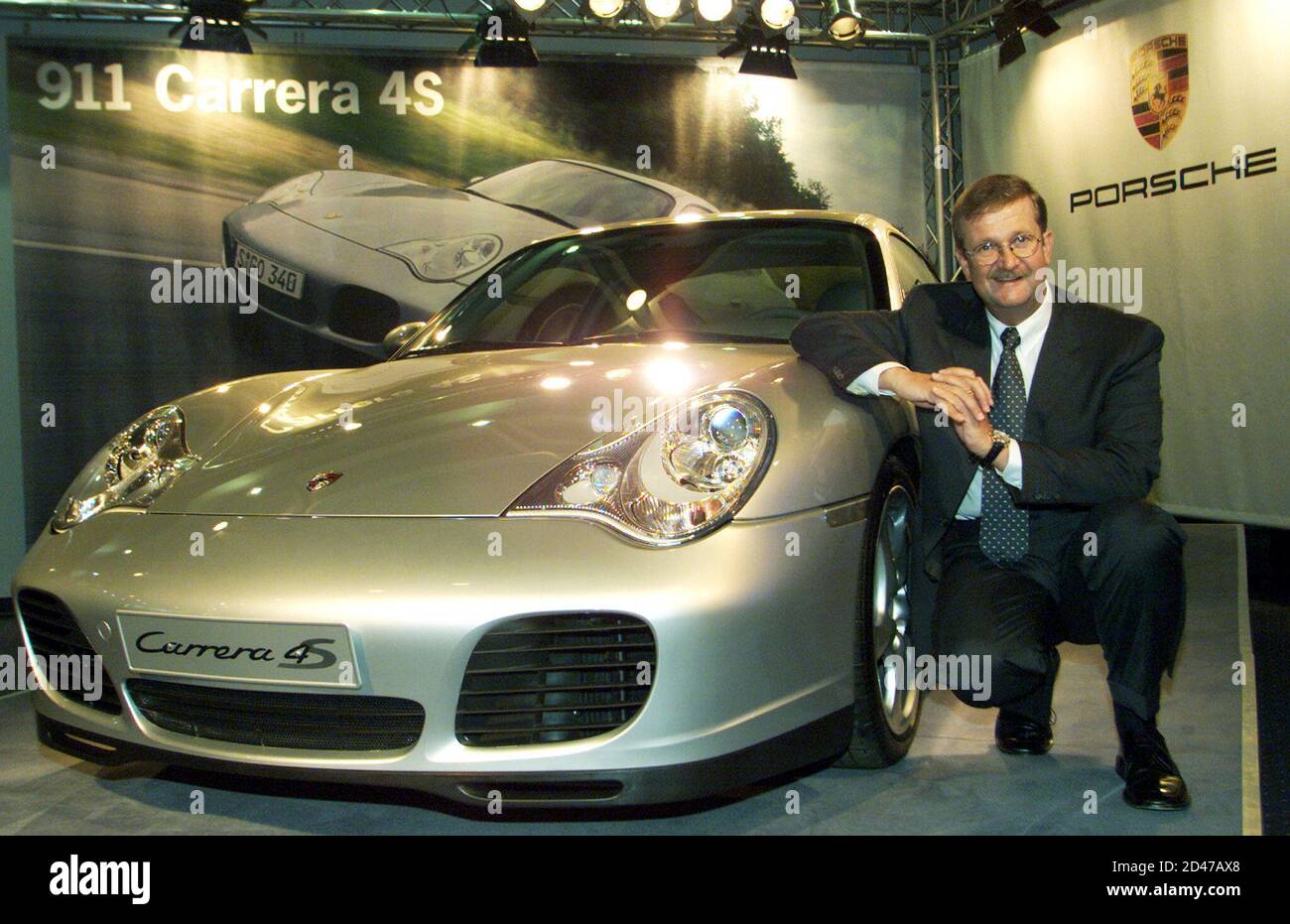 Porsche CEO Wendelin Wiedeking poses beside a Porsche Carrera 4S at the  world biggest car show the 59th IAA in Frankfurt September 11, 2001.  Porsche unit sales rose 12 percent to 54,586
