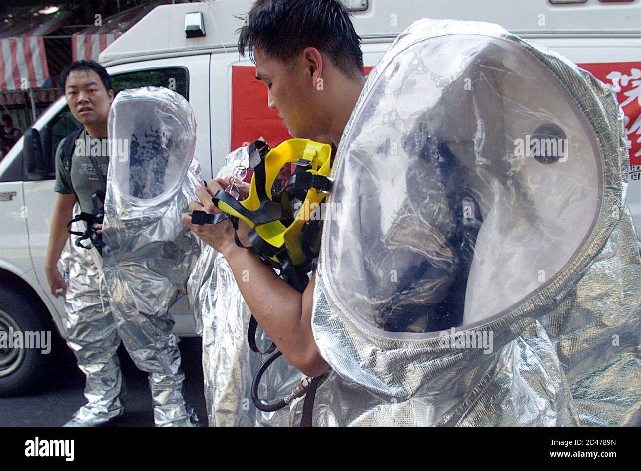 Taiwan emergency rescue members take off their chemical protection suits after a mock poison gas attack at an underground station in Taipei on October 27,2001. Taiwan, which supports the U.S.-led strikes against Afghanistan, continues to conduct security exercises. REUTERS/Simon Kwong  SK/JIR Stock Photo