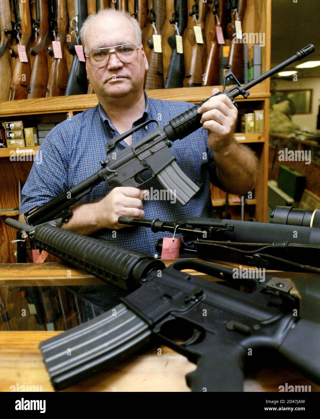 Gun dealer Tom Mannewitz displays several United Statesmade assault