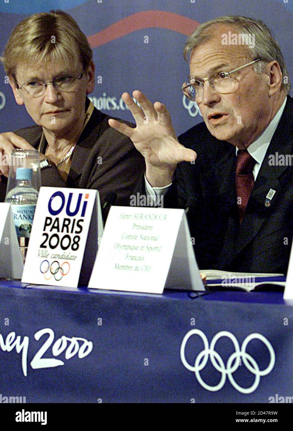 French Youth and Sports Minister Marie-George Buffet (L) listens as Paris  2008 president Claude Bebear (R) makes a point during a news conference in  this September 16, 2000 file photo. Claude Bebear