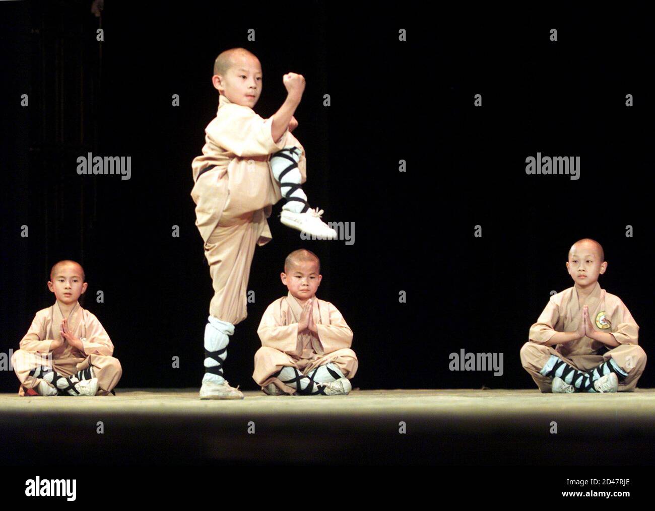 Young monks from Shaolin Martial Monks Troupe of Songshan perform Shaolin Kung Fu during the rehearsal of performance 'Shaolin Heroes' in Hong Kong July 20, 2001. The performance will be held in the territory in July. Stock Photo