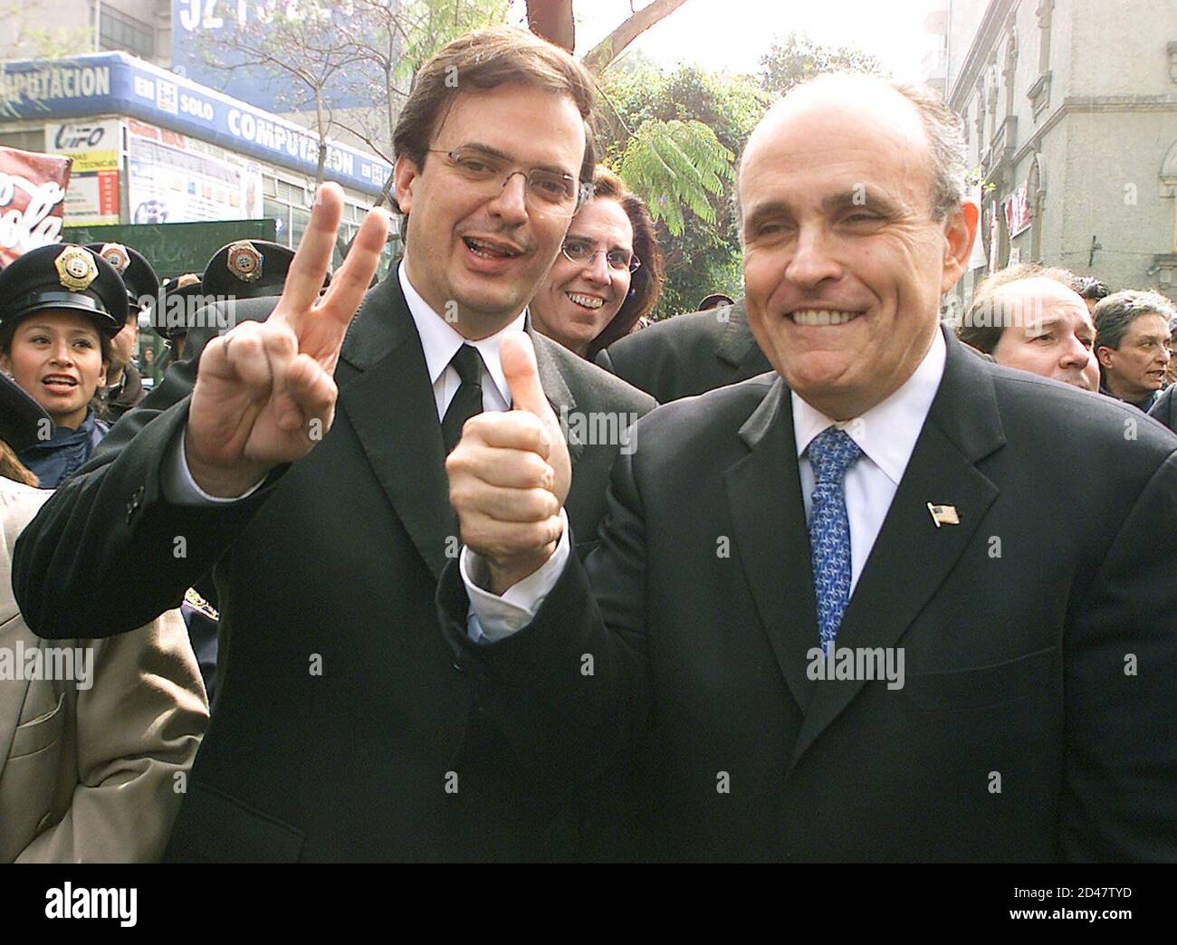 Former New York Mayor Rudy Giuliani (R) and Mexico City's police chief Marcelo Ebrad tour along a street in a popular Mexico City district on January 14, 2002. Famed for taming the wild streets of New York in the 1990s with his 'zero tolerance' crime policy, Giuliani has been hired for $4.3 million by a group of prominent Mexican businessmen to reduce Mexico City's dizzying crime rate. REUTERS/Daniel Aguilar  DA Stock Photo