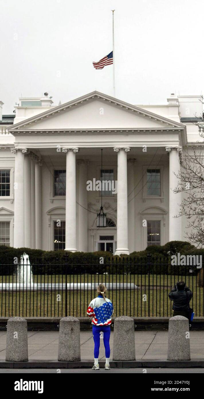 A Woman Wearing A Stars And Stripes Jacket Looks Toward The White House Where The American Flag Flies At Half Staff After The Loss Of The Space Shuttle Columbia February 1 2003