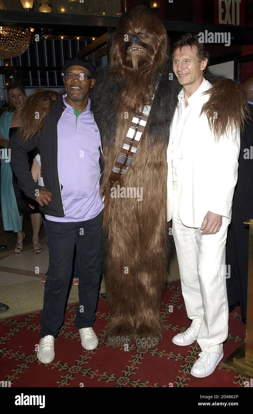 Actors Samuel L. Jackson (L) and Liam Neeson (R) pose with Darren Blum (C) dressed as Chewbacca at the premiere of Star Wars Episode III, Revenge of the Sith in New York, May 12, 2005. The movie opens nationwide May 19. Stock Photo