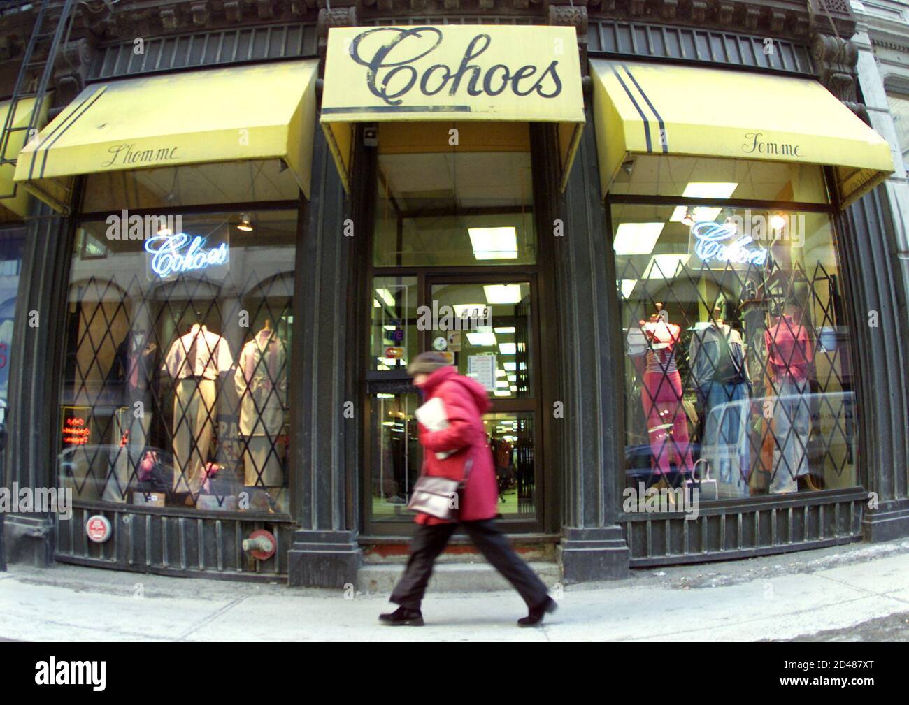 A pedestrian passes a Cohoes clothing store in downtown Montreal, March 1,  2001. The Canadian Mounties seized thousands of counterfeit Tommy Hilfiger,  Calvin Klein and other designer clothes worth more than C$800,000