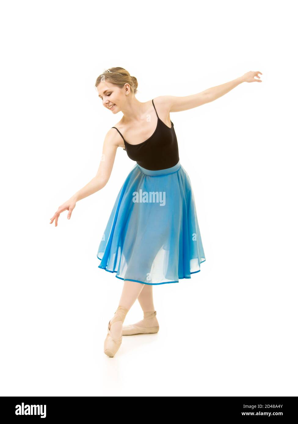 woman in a blue skirt and a black leotard dance ballet. Studio shot on