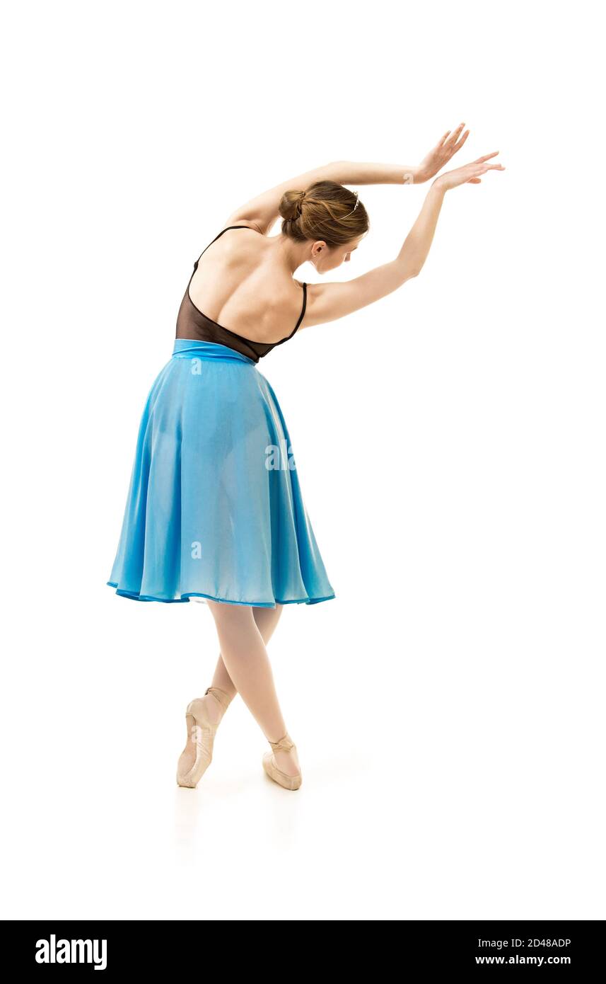 woman in a blue skirt and a black leotard dance ballet. Studio shot on