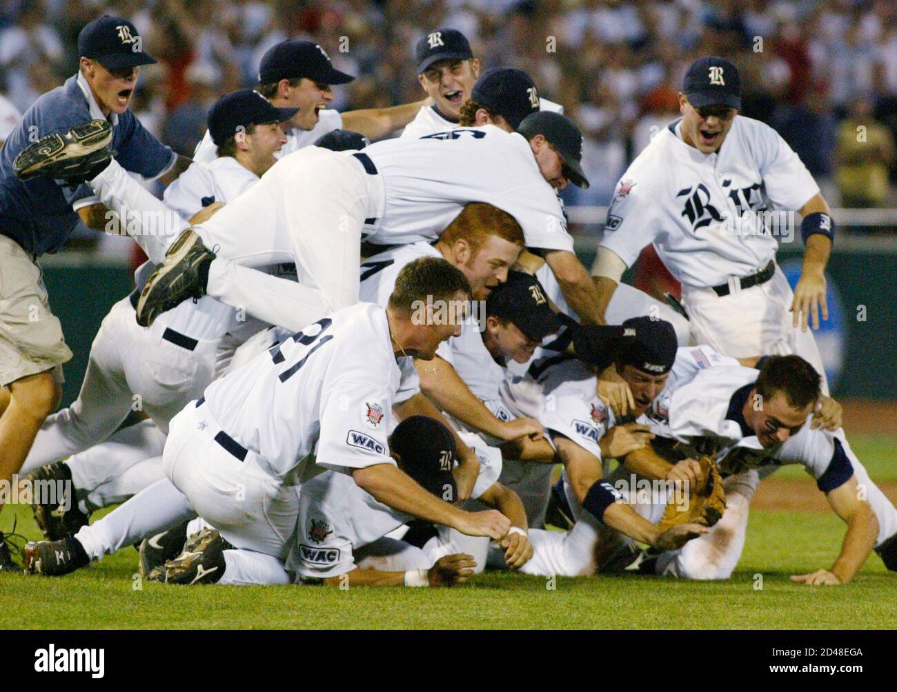 Rice Owls players celebrate winning the College Baseball World Series, beating Stanford two games to one in Omaha, Nebraska June 23, 2003. The 14-2 victory gave Rice their first national championship in any NCAA team sport. At left is Rice pitcher Philip Humber (21), who pitched a complete game. REUTERS/Rick Wilking RTW/SV Stock Photo