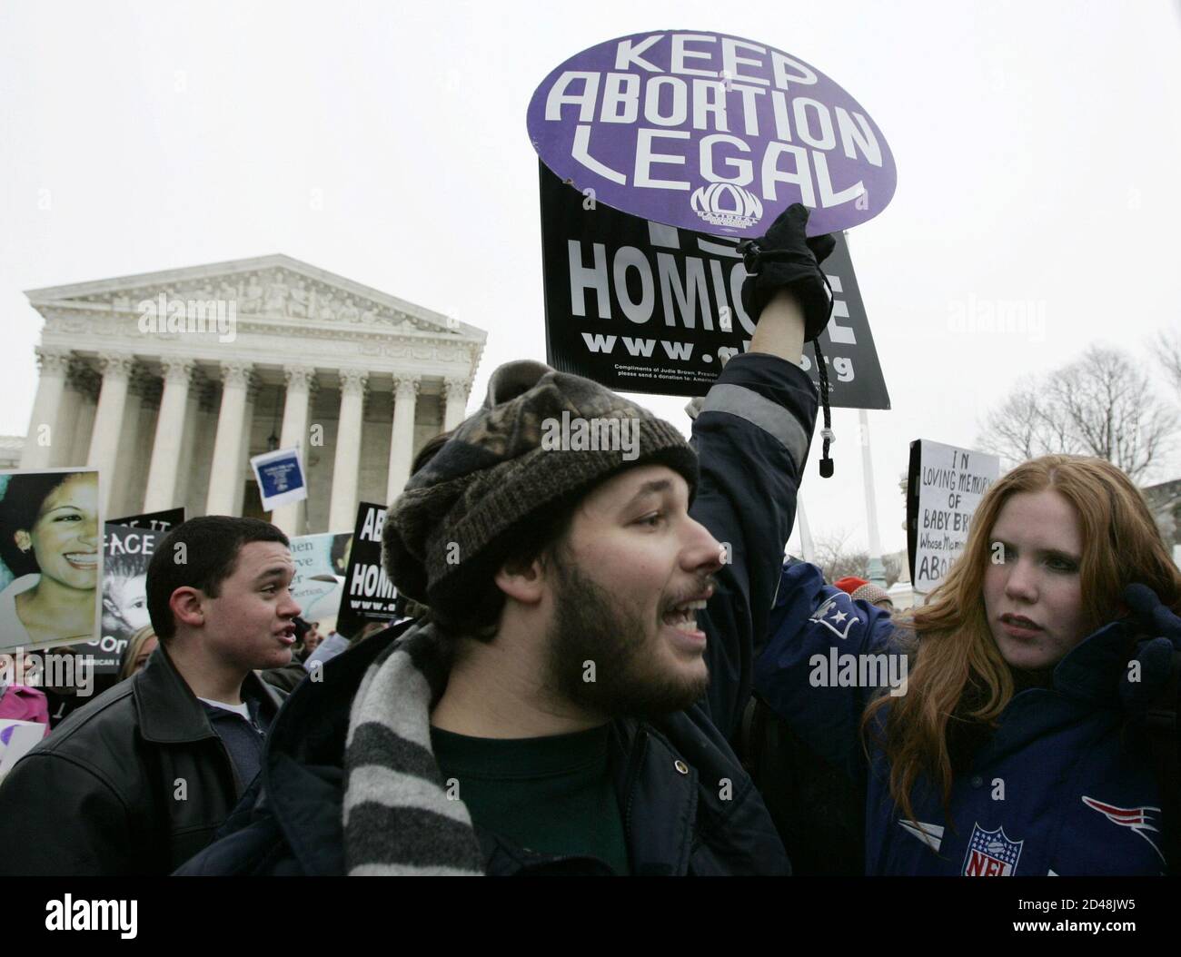 Pro-choice activist Luqman Clark (L), of Arlington, VA, argues with anti-abortion protestor Jessica Meunir, from Massachusetts, outside the U.S. Supreme Court in Washington January 24, 2005, during the 32nd annual March For Life protest against the Supreme Court's 1973 Roe v. Wade abortion rights decision. Thousands of pro-life activists marched to the Supreme Court where they were met by a handful of pro-choice campaigners. REUTERS/Jason Reed  REUTERS Stock Photo
