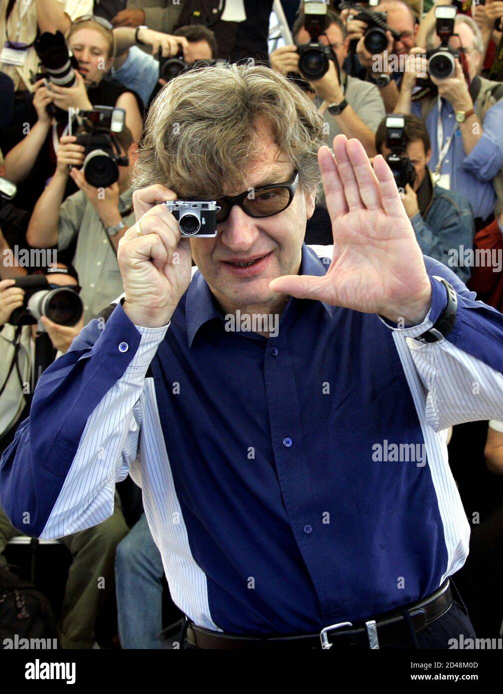 German director Wim Wenders poses with a camera during a photocall for his  in-competition film "Don't Come Knocking" at the 58th Cannes Film Festival  May 19, 2005 Stock Photo - Alamy