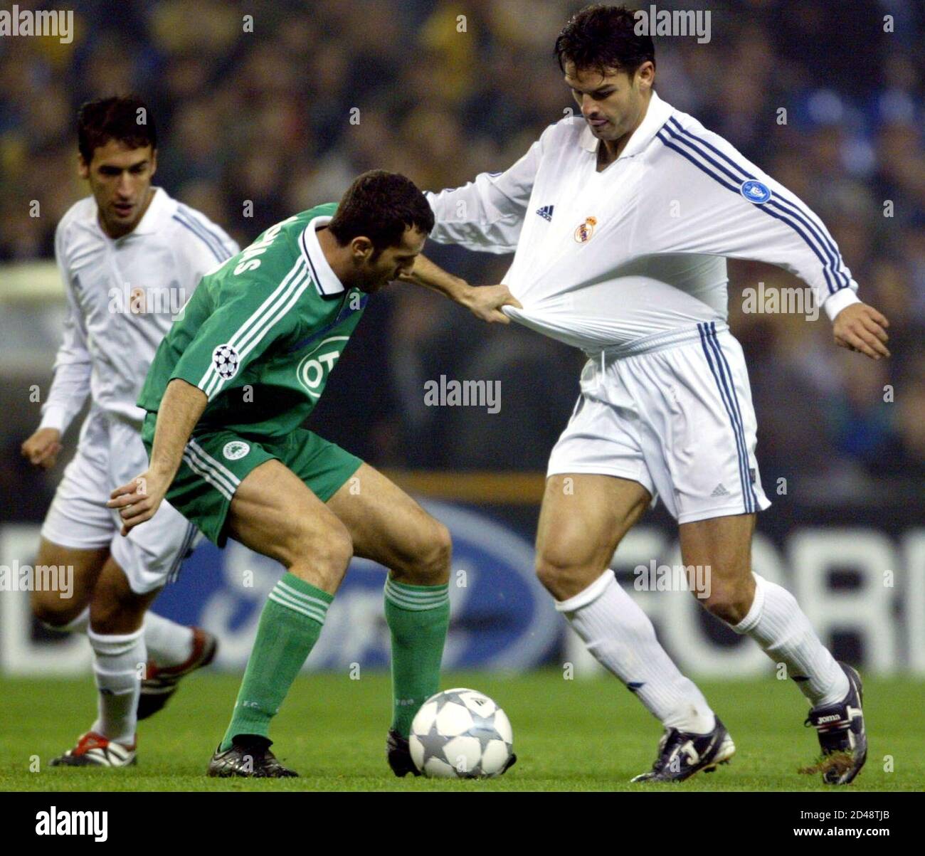 Real Madrid's Fernando Morientes (R) is grabbed by Panathinaikos' Ioannis  Goumas as Real Madrid's Raul Gonzalez (L) looks on during their Champions  League group C soccer match at Santiago Bernabeu stadium December