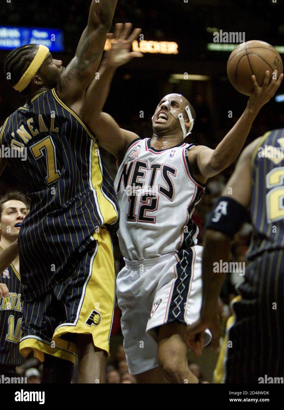New Jersey Nets guard Lucious Harris (12) drives into the defense of  Indiana Pacers forward Jermaine O'Neal during action in the second quarter  of Game 2 of their NBA Eastern Conference playoff