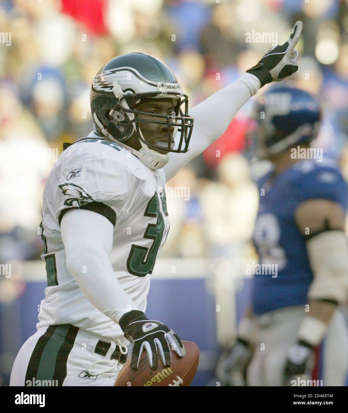 Philadelphia Eagles saftey Michael Lewis celebrates his first quarter  interception in the end zone against the New York Giants during the first  quarter of their NFL game at Giants Stadium in East