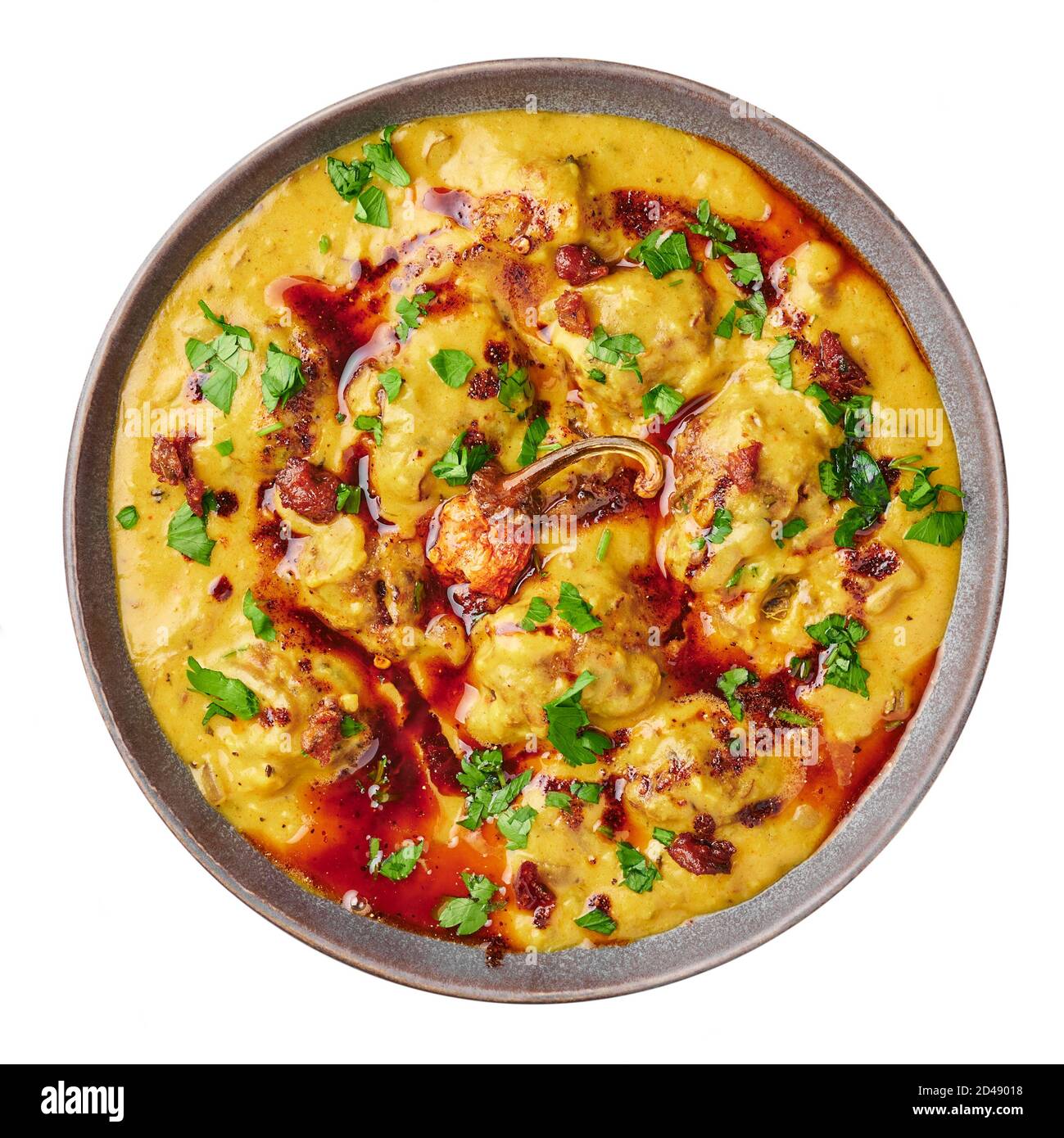 Punjabi Kadhi Pakora in gray bowl isolated on white. Kadhi Pakoda is