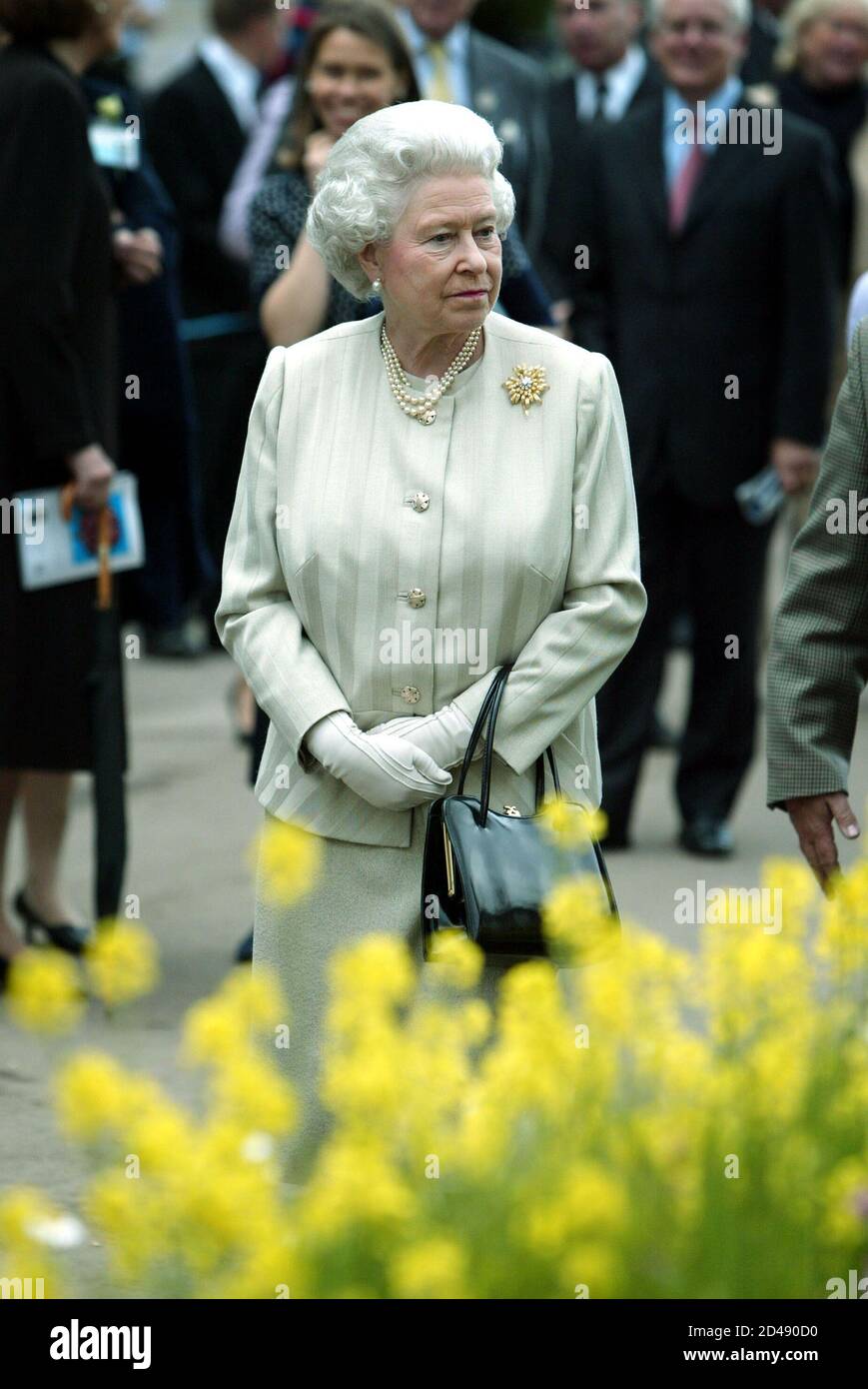Britain's Queen Elizabeth II examines exhibits during her visit to the Royal Horticultural Society's Chelsea Flower Show in London May 19, 2003. Thousands of visitors are expected to attend the 81st annual show, organised by the Royal Horticultural Society and held at the Royal Hospital in Chelsea, west London. REUTERS/Stephen Hird SH/NMB Stock Photo