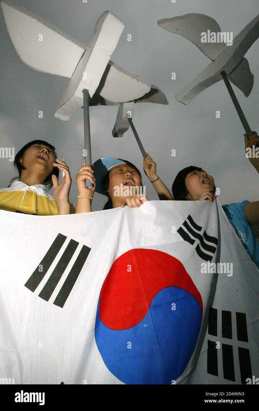 South Korean Middle School Girls Hold The National Flag And Statues Of Birds Symbolising Peace 