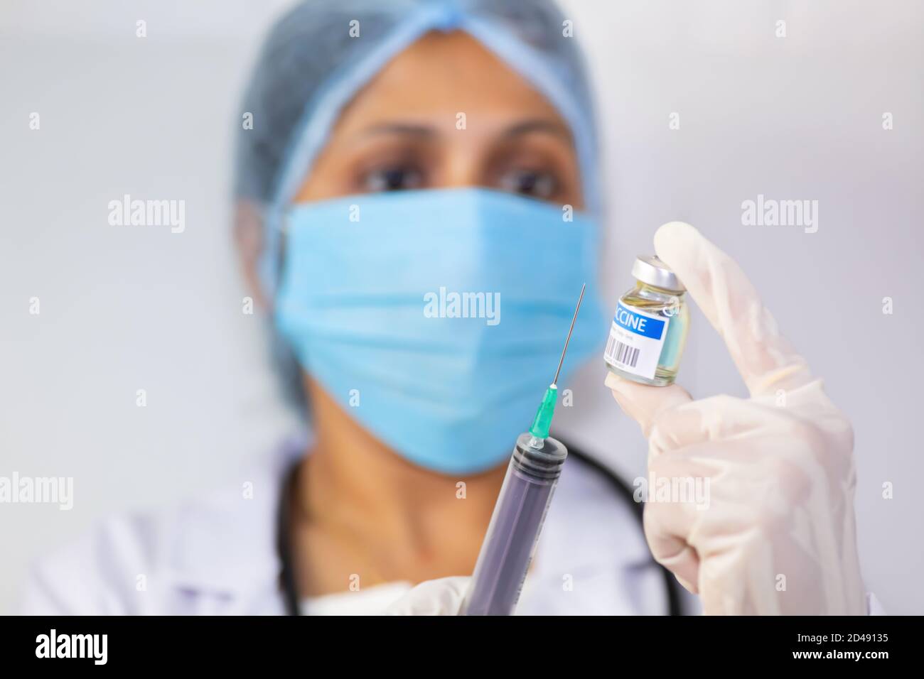 Indian doctor draw medication into an injection syringe from a vaccine bottle Stock Photo Alamy