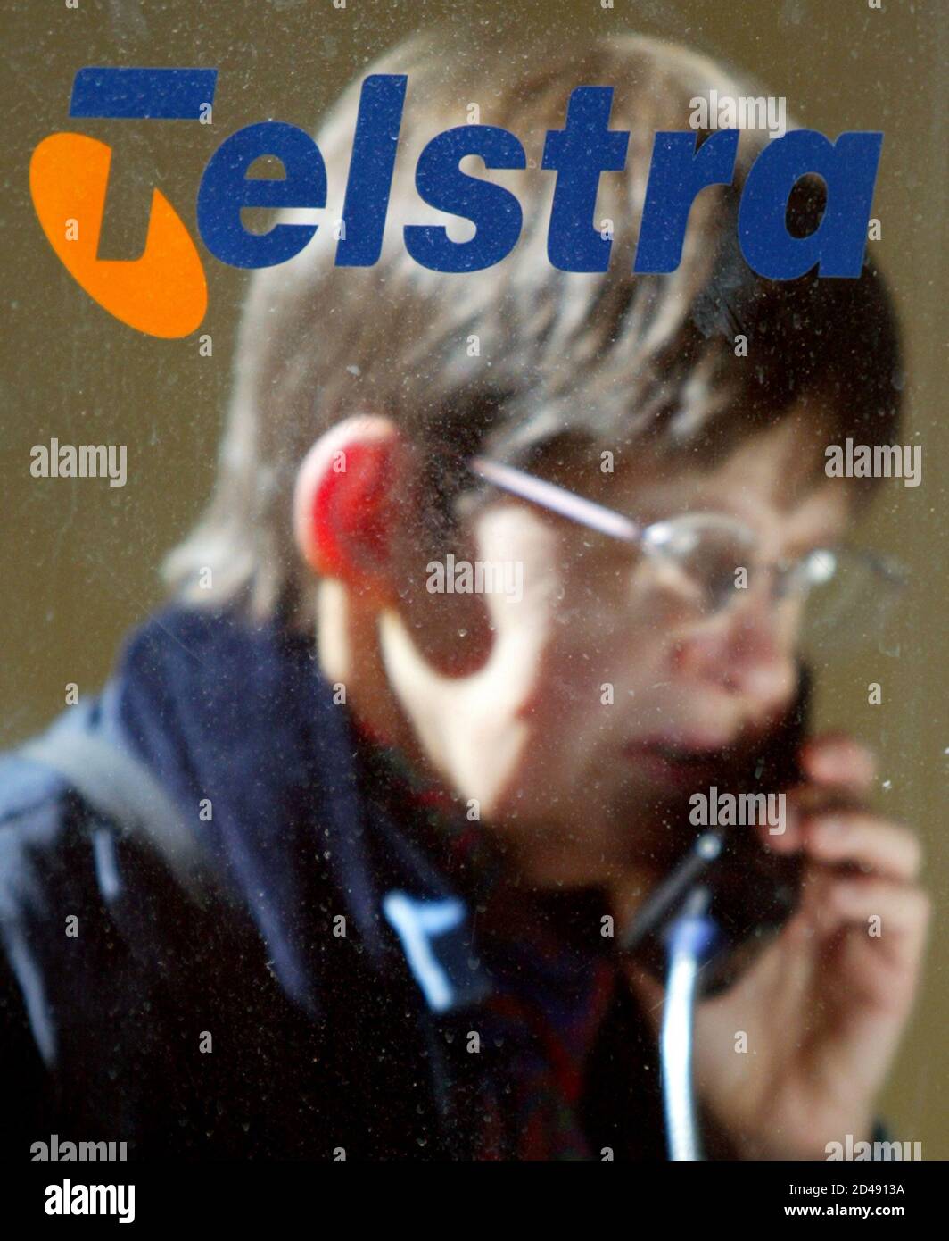 A customer of Telstra uses a public payhone in Sydney's central business  district August 28, 2003. Australia's biggest phone company beat market  expectations for a strong second half profit with cost cuts