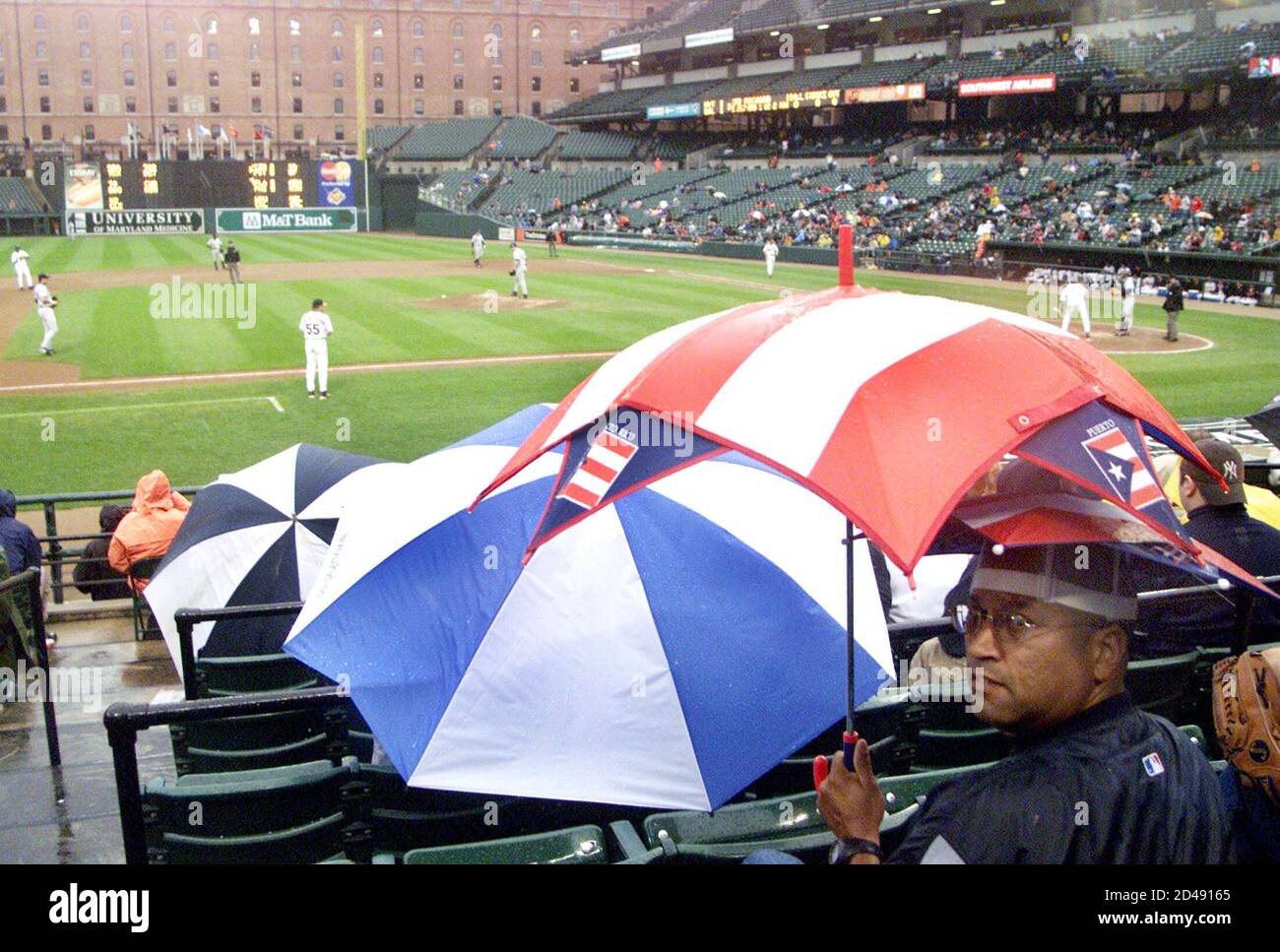 Fans sit under umbrellas hires stock photography and images Alamy