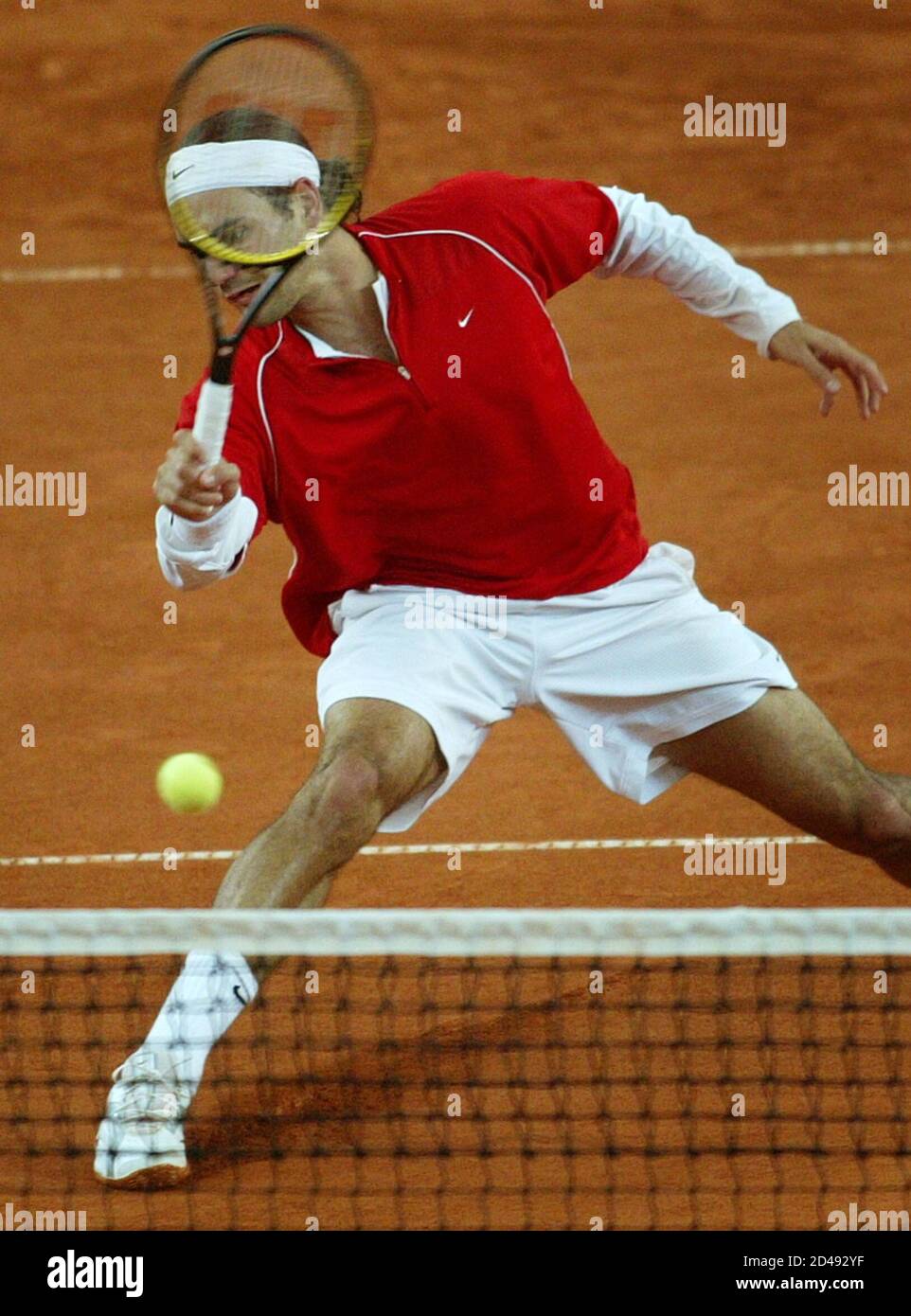 SWISS FEDERER SLIDES TO REACH A BALL DURING MATCH AGAINST GAUDIO FROM  ARGENTINA AT TENNIS MASTERS IN HAMBURG. Swiss Roger Federer slides to reach  a ball during his match against Gaston Gaudio