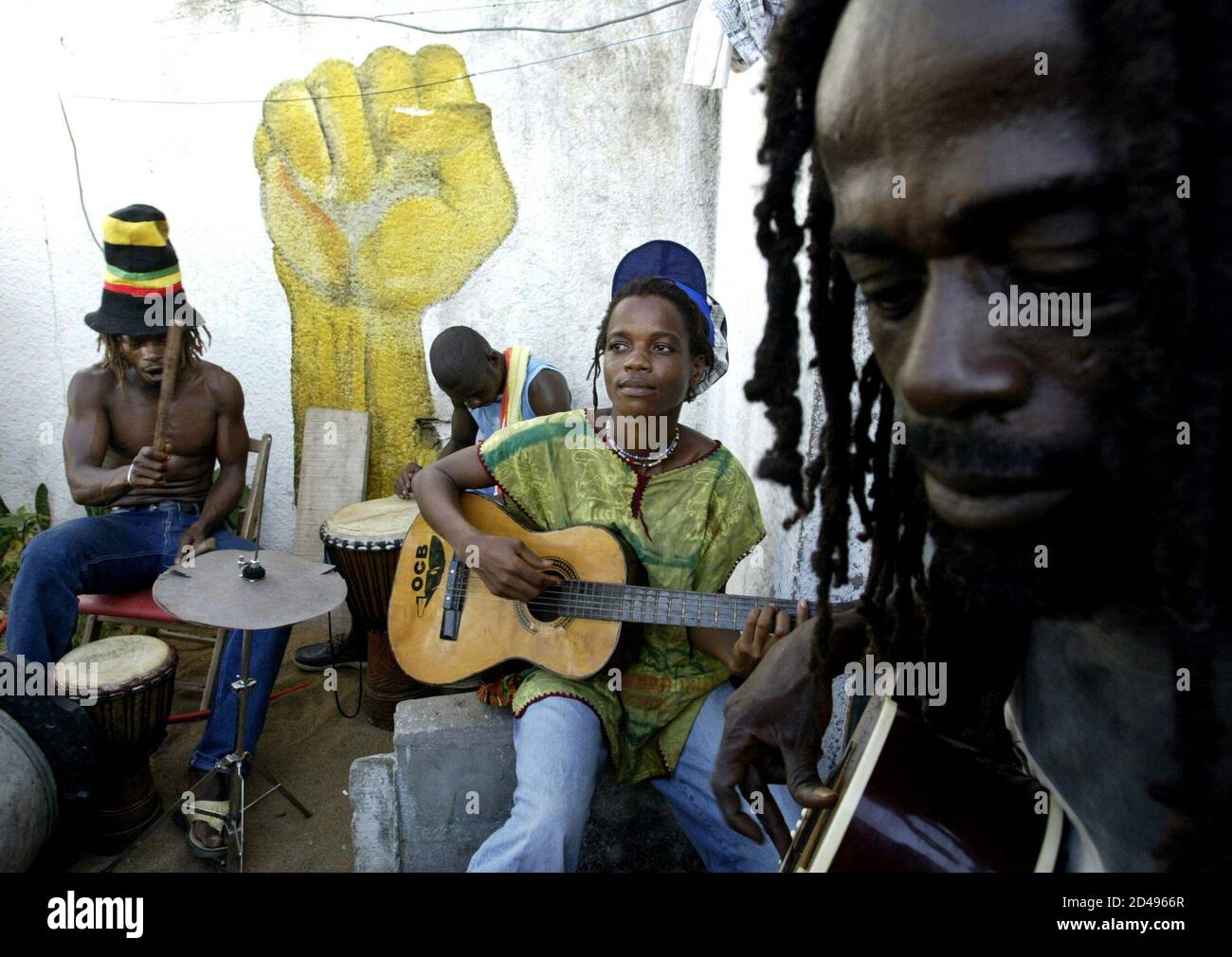 Members of an Ivorian Rastafarian community perform during a music session called 'Naya Bingue' one day before the 24th anniversary of the death of reggae icon Bob Marley at the Rastafarian village of Virdi, south of the Ivorian capital Abidjan, May 10, 2005. Marley died on May 11, 1981. Picture taken May 10, 2005. Stock Photo