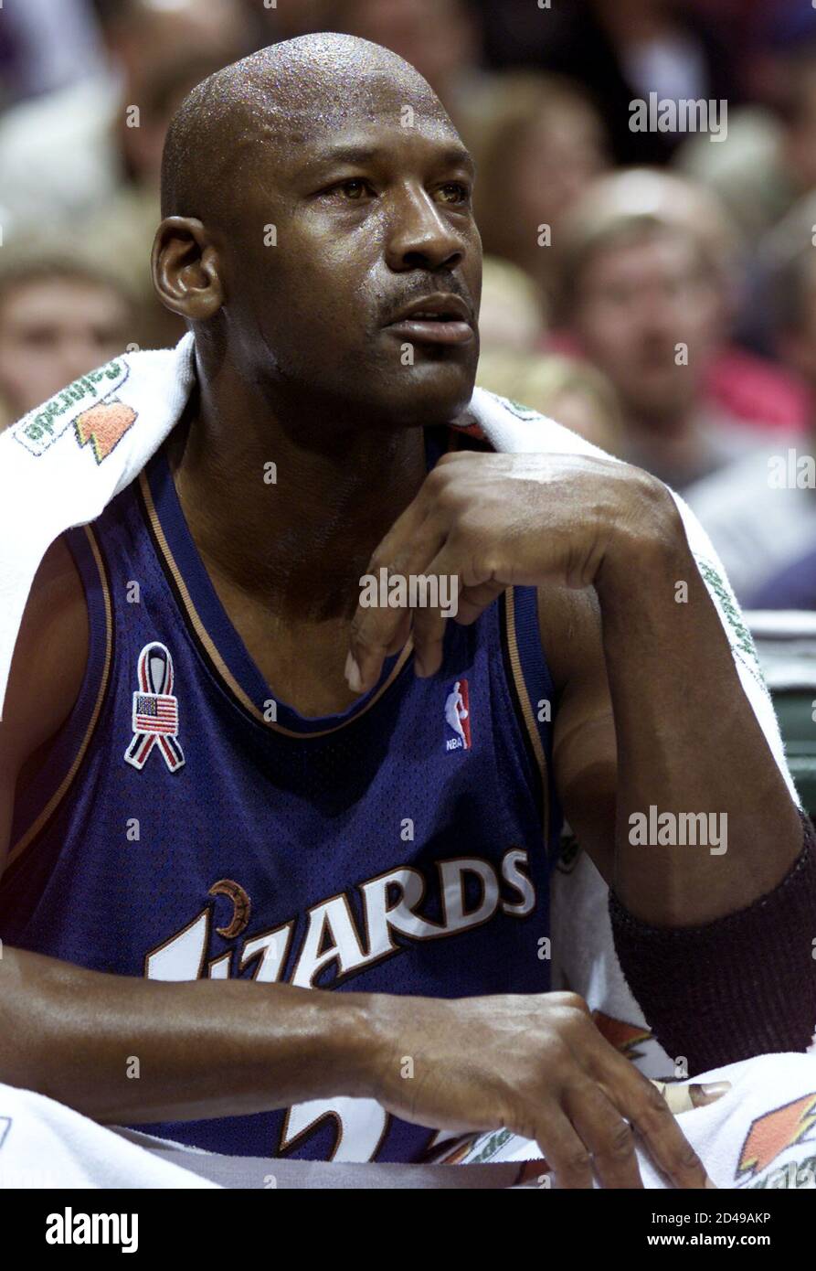 Washington Wizards' forward Michael Jordan takes a break and watches from  the bench late in the first quarter at the Bradley Center in Milwaukee,  Wisconsin January 11, 2002. Jordan scored 22 points,