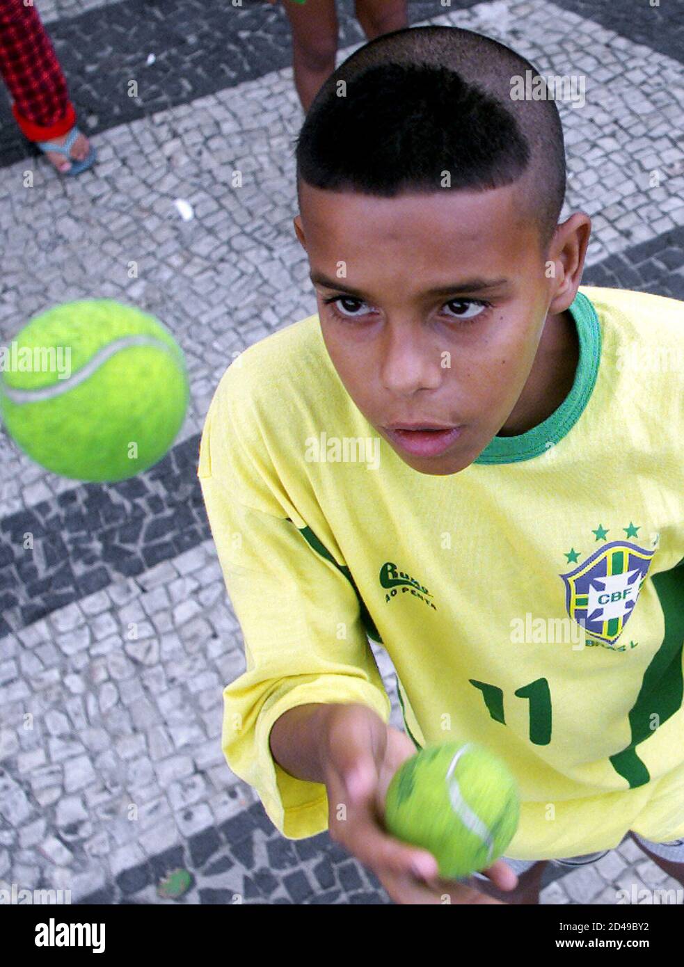 Fabiano de Lima, 15, sporting the hair style of Brazilian soccer star  Ronaldo, juggles tennis balls after [Brazil defeated Germany 2-0] in the  World Cup Final, in Rio de Janeiro June 30,