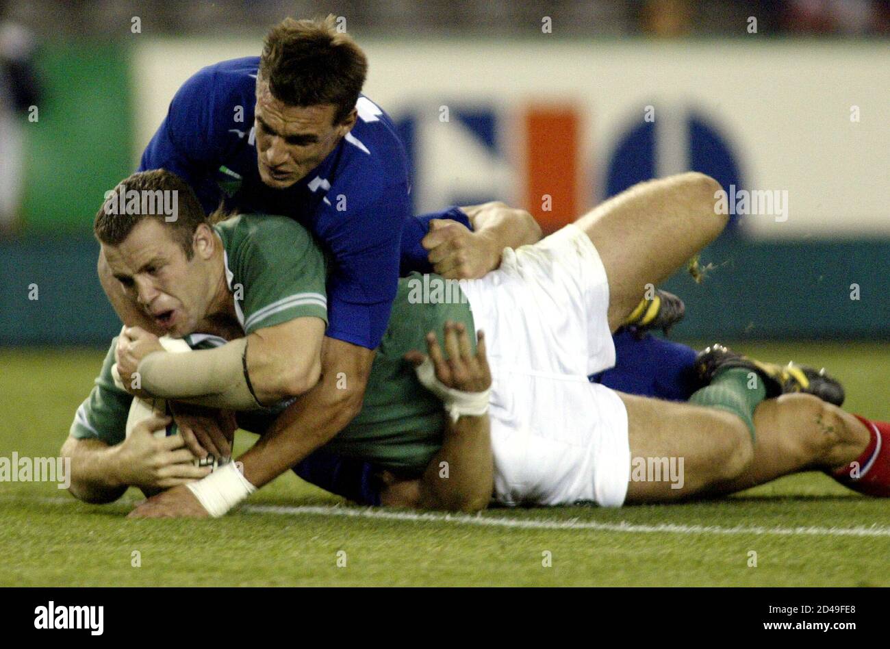 Ireland's Kevin Maggs breaks past the tackle of France's Nicolas Brusque to score during their 2003 Rugby World Cup Pool quarterfinal match at the Docklands Stadium in Melbourne, November 9, 2003. Stock Photo