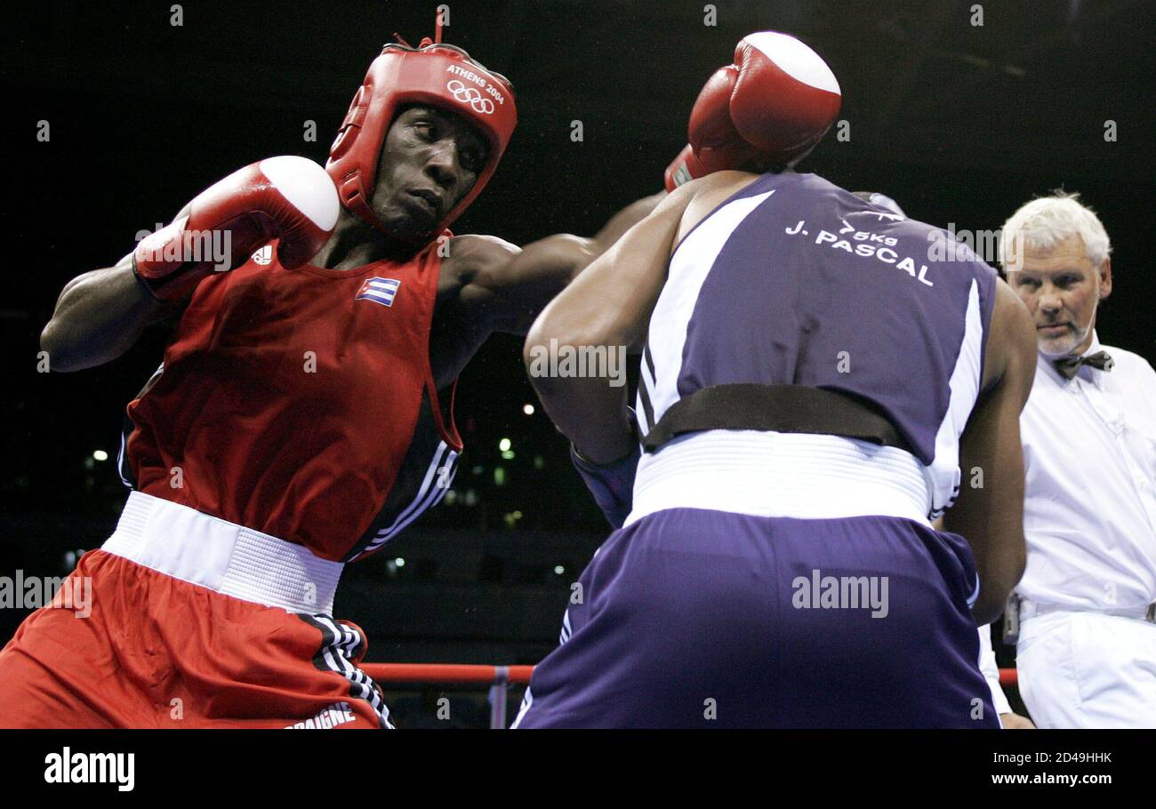 Yordani Despaigne Herrera of Cuba (L) lands a punch on Jean Pascal of Canada during their middle weight (75 kg) first round boxing bout at the Athens 2004 Olympic Summer Games August 14, 2004. Despaigne Herrera won the fight. Stock Photo