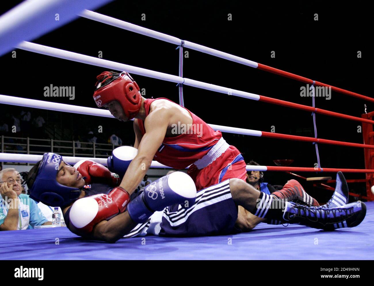 Cuba's Yuriorkis Gamboa Toledano (L) fights on the canvas Thailand's Somjit Jongjohor in their men's flyweight (51kg) round of 16 bout at the Athens 2004 Olympic Summer Games August 21, 2004. Gamboa Toledano won the bout. Stock Photo