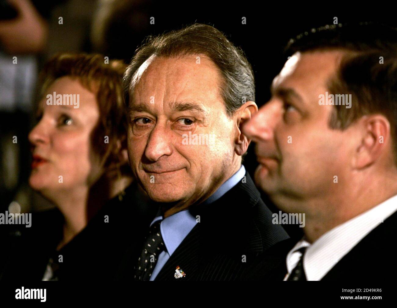 Paris's Mayor Bertrand Delanoe (C) looks at French sports Minister Jean-Francois Lamour during the International Olympic Committee Evaluation Commission press conference in a Paris hotel, March 12, 2005. The IOC evaluation commission is ending a 4-day visit to examine Paris'bid for the 2012 Summer Olympic Games. Stock Photo