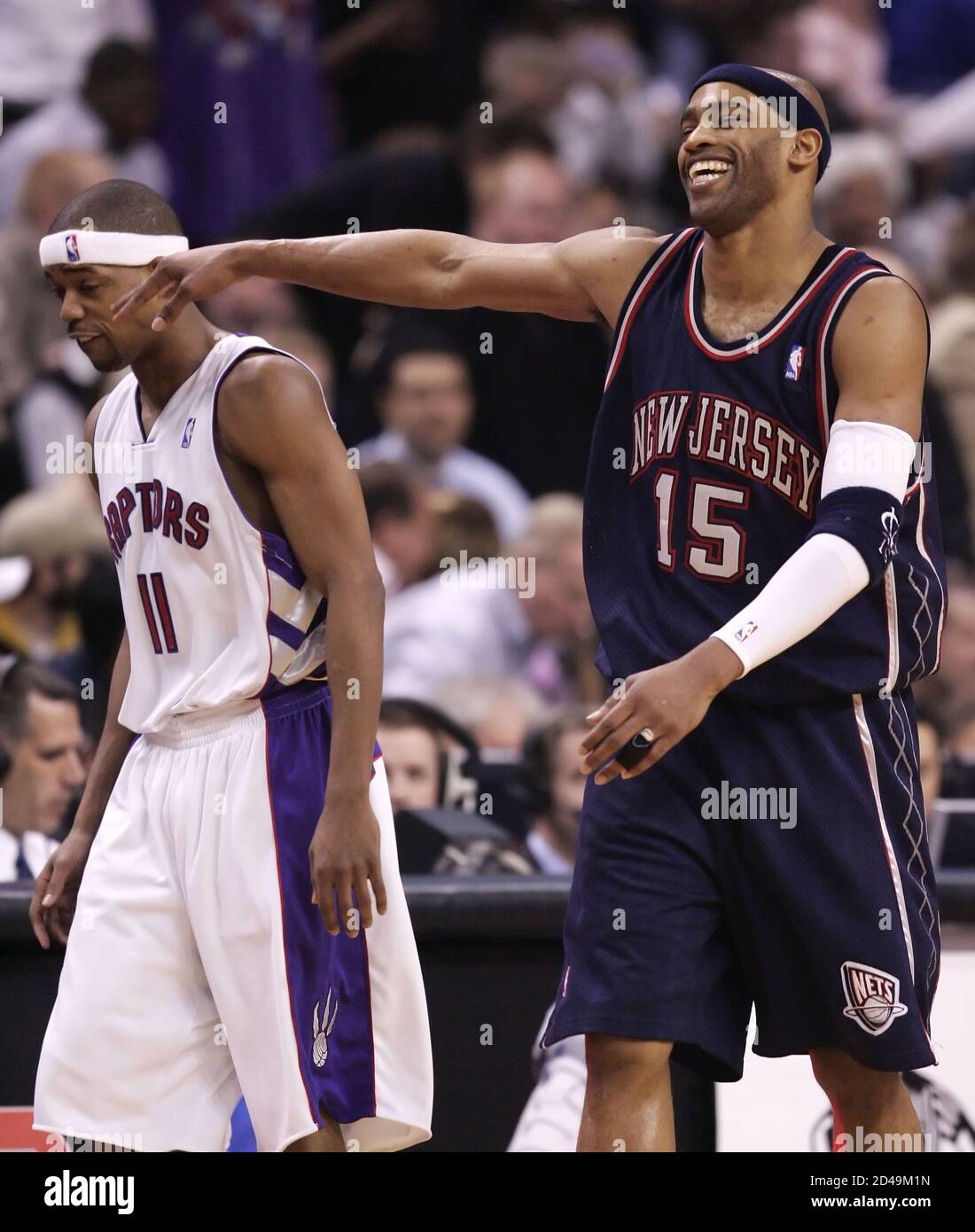 New Jersey Nets guard Vince Carter (R) playfully hits Toronto Raptors guard  Rafer Alston as they leave the floor at half time in the NBA game in  Toronto, April 15, 2005. This