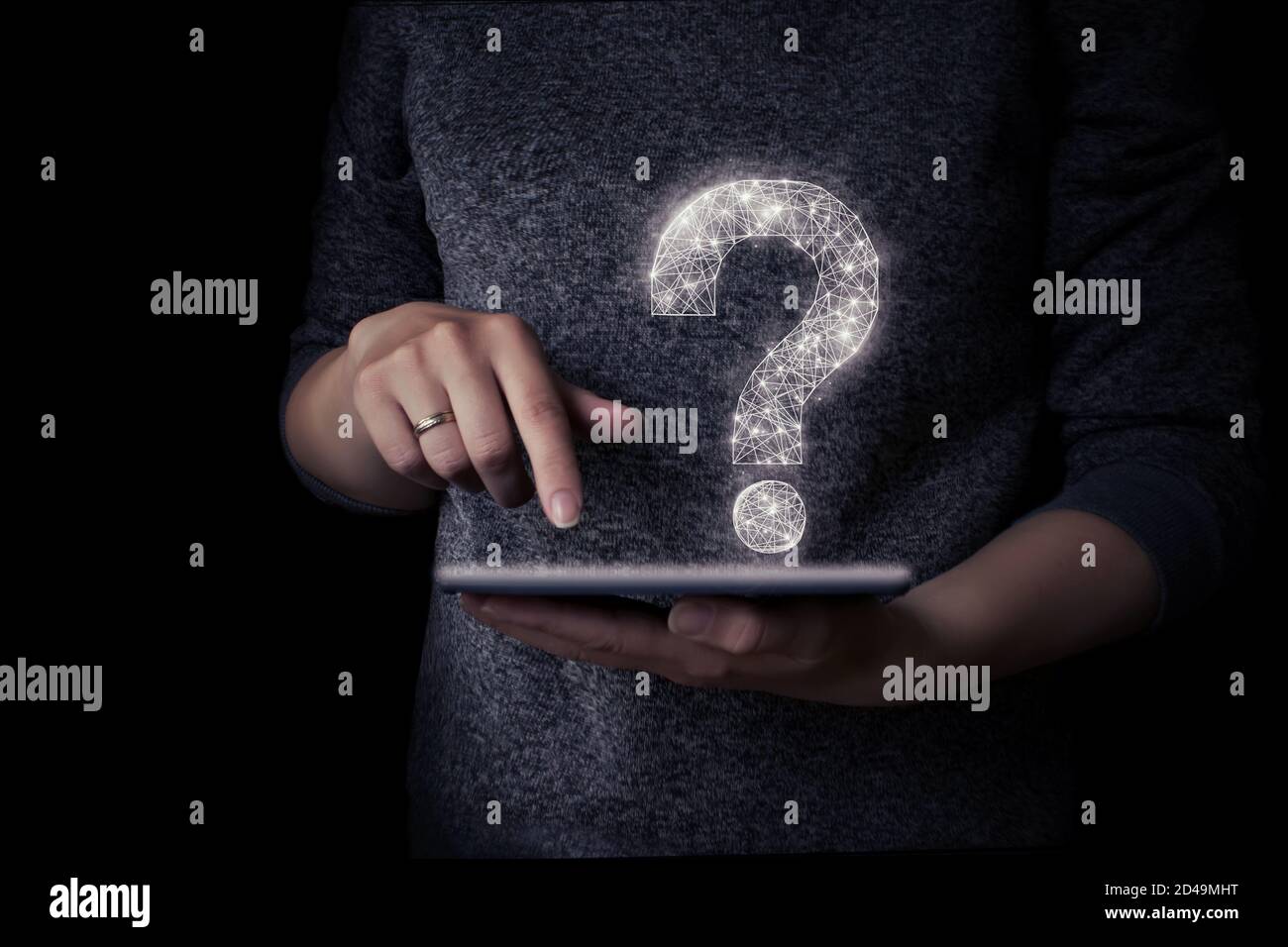 Girl's hand holds tablet with virtual hologram question mark Stock Photo