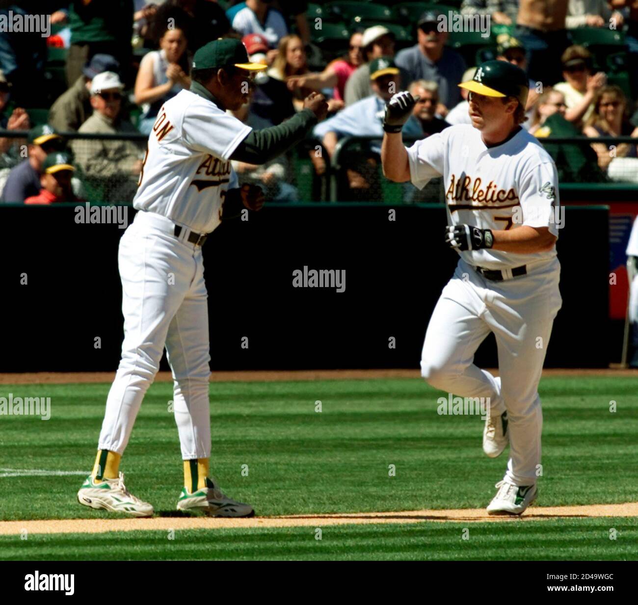 Oakland A S Jeremy Giambi 7 Is Congratulated By A S Third Base Coach Ron Washington After Hitting A Solo Home Run Off Anaheim Angels Starting Pitcher Ramon Ortiz In The Sixth Inning Of