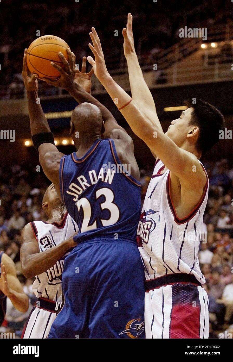 Houston Rockets' center Yao Ming (R) defends against Washington Wizards'  guard Michael Jordan (23), who dishes the ball to a teammate, in the second  half of NBA action, November 22, 2002 in