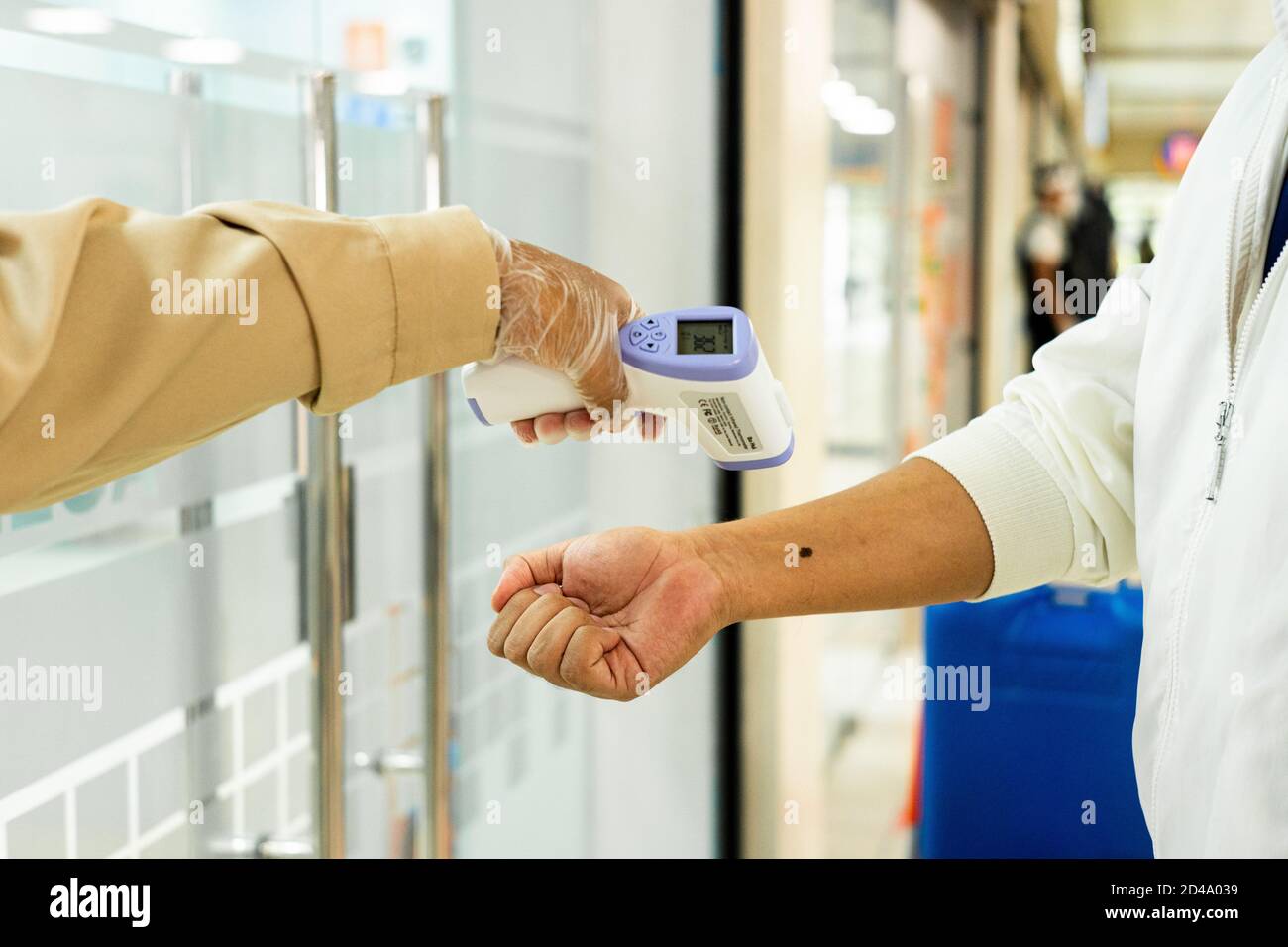 Doctor measuring patient's temperature with an infrared thermometer