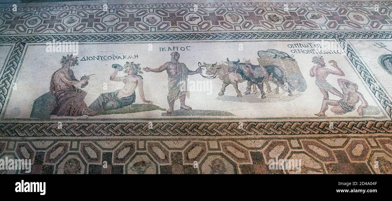 House of Dionysos: Dionysos & Acme are depicted (left) with Icarios holding the reins of an ox-driven double wheeled cart, filled with sacks of wine. Stock Photo