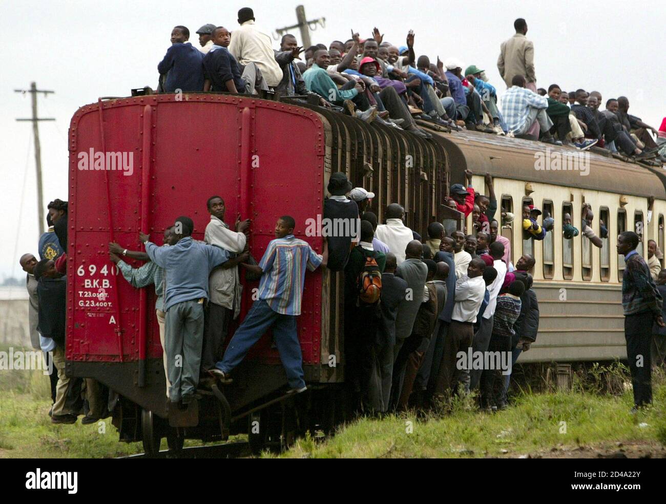 Kenyan commuters overload a train transporting them to the capital Nairobi November 20, 2003, after public minibuses began their strike yesterday. Kenyans were still being forced to walk long distances to work after public minibuses striked to protest a government order that they fit seatbelts and speed limit devices to curb road accidents. [The new govenment of president Mwai Kibaki had said it is determined to bring order to Kenyas public transport sector and end the chaos on the roads which claims about nine lives a day.] Stock Photo