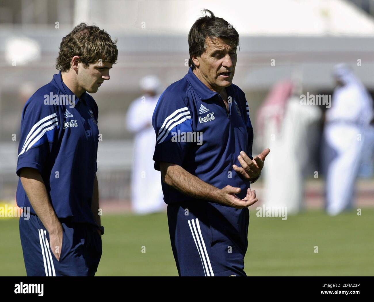 Argentina's Under 20 soccer team coach Hugo Tocalli (R) talks to player  Walter Montillo during their training session at Al Shaab Sports Club in  Sharjah, November 27, 2003. Argentina will face Spain