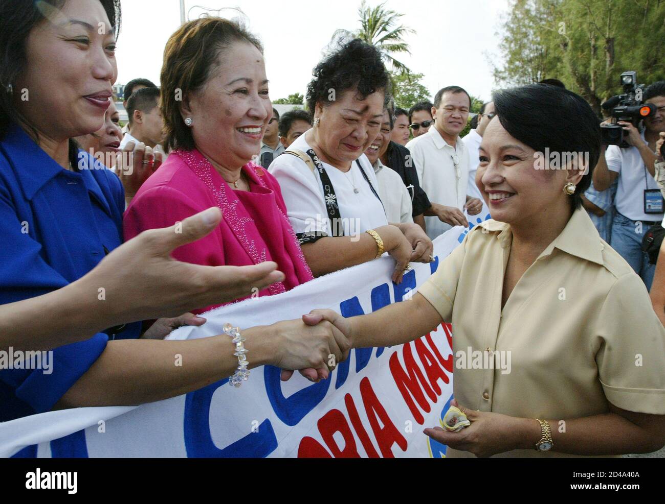 Philippine President Gloria Macapagal Arroyo is greeted by supporters upon  her arrival at the Mactan air force base in Cebu city, central Philippines,  June 21, 2004. Arroyo prepared on Monday for a