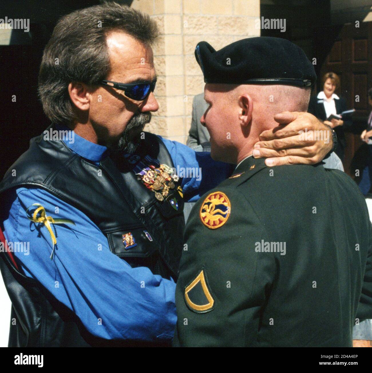 Tom Titus (L) greets a soldier during the funeral of his son, U.S. Soldier Brandon Titus, in Boise, Idaho, August 30, 2004. Tom Titus, experienced the shock of watching his best friend die in his arms during the Vietnam War in 1971. On Monday, the ex-Army Ranger felt the even greater horror of burying his only son Brandon, 20, killed on August 17 by an explosion while patrolling a Baghdad slum. Such a scene of grief has played out nearly 1,000 times since the United States invaded Iraq last year. Yet Americans rarely hear much about their fallen soldiers, who typically appear as a name or phot Stock Photo
