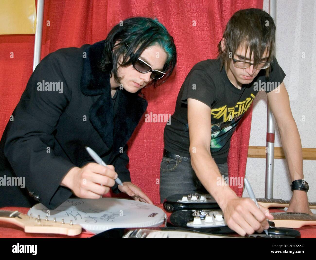My Chemical Romance Singer Gerard Way L And His Brother Bassist Mikey Way Autograph Guitars Backstage At Kxte X Treme Radio S Annual Holiday Havoc Concert At The Thomas Mack Center In Las